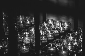 Candles sitting on a rack black and white