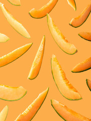 Slices of cantaloupe melon on marigold background.
