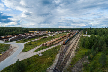 Hyrynsalmi railway yard with log wood waiting for railway transport to saw mills, Finland - 398959984