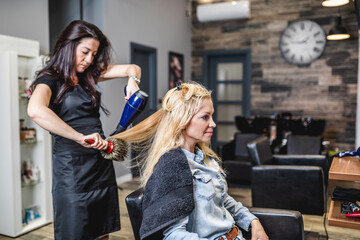 Beautiful blond middle-aged woman in modern hair salon.