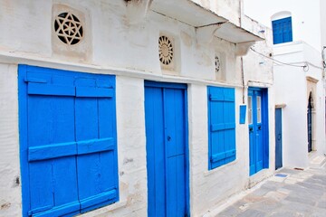 View of a house decorated with blue door and windows and marble lintel at the traditional village of Pyrgos in Tinos island, Greece, April 14 2012.