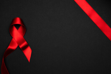 Infection symbol. Red ribbon symbol in hiv world day on dark background. Awareness aids and cancer. Healthcare and medical concept.