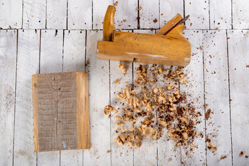 Planing wood with hand tools. Minor carpentry work performed in the workshop.