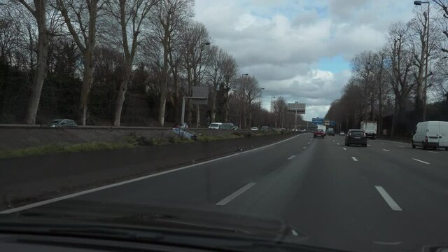 Windshield View. Driving Car Moving Along Highway in Paris Suburbs. France Europe. 2x Slow motion 60 fps