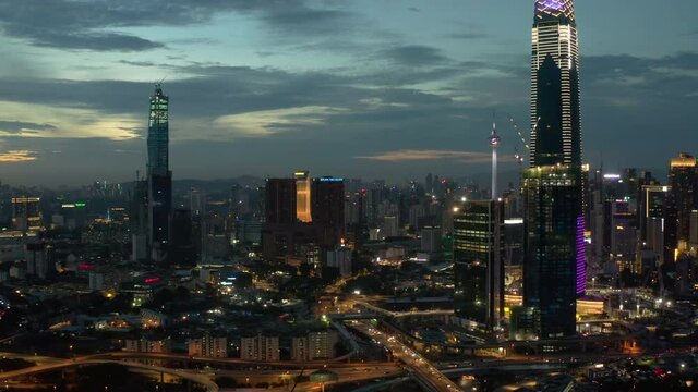 Establishing aerial cinematic drone b-roll shot of sunset at Kuala Lumpur city skyline. 