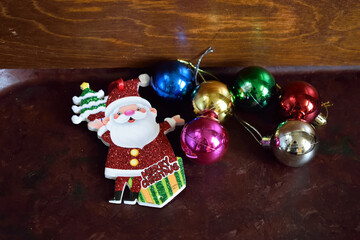 Fototapeta na wymiar Christmas toys, Santa Claus, colored balls on a wooden background