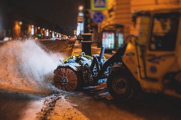 Process of snow removal on the city streets and roads with municipal vehicle, bulldozer, snowblower...