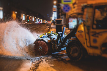 Process of snow removal on the city streets and roads with municipal vehicle, bulldozer, snowblower...