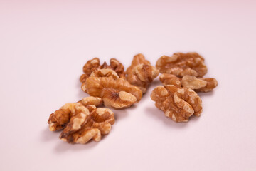 several walnuts laid out on a white background isolated close-up