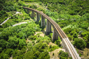 Fototapeta na wymiar The old railway bridge of the Asopos river near village Iraklia at national park of Oiti, Greece