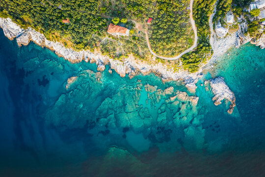 Aerial drone summer background, shot of beautiful beach with rocks and sand on Greece. Best beaches of Mediterranean. © Mariana Ianovska
