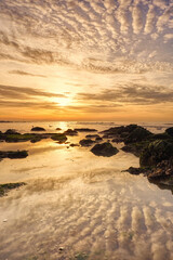 Fototapeta na wymiar Beautiful sunset on the beach. Seascape at the sunrise. An impressive golden sky