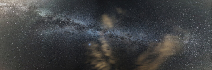 panorama of milkyway galaxy on sky above on summer night with clouds