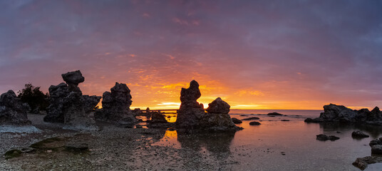 Typical limestone rocks from Gotland. They are called rauks or rauk-fields. Sunrise over the Baltic Sea.