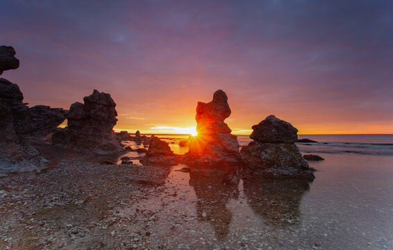 Typical limestone rocks from Gotland. They are called rauks or rauk-fields. Sunrise over the Baltic Sea.
