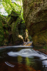 Red water stream in scotland with waterfall