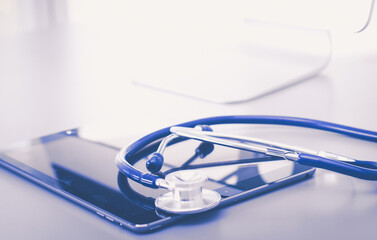 Medical equipment: blue stethoscope and tablet on white background. Medical equipment
