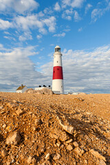 Fototapeta na wymiar Portland Bill Lighthouse. Dorset coast in Isle of Portland, UK. A sea way-mark guiding vessels navigating in the English Channel.