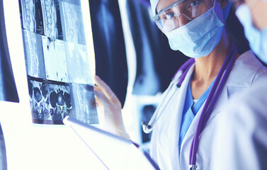 Two female women medical doctors looking at x-rays in a hospital.