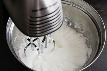 Beating Egg Whites to Make Meringue: Egg whites that have been beaten in a stand mixer until they are fluffy