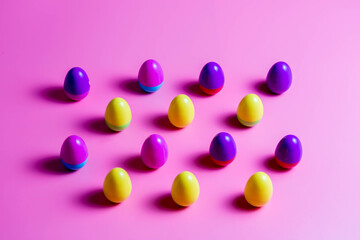 Colorful Plastic Easter Eggs on pink background
