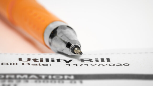 Close up shot of pen tip on utility bill
