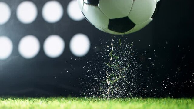 Super slow motion of falling soccer ball on lawn. Filmed on high speed cinema camera, 1000fps.