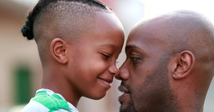 Beautiful father and child bonding together. African black parent and son bonding, doing eskimo kiss