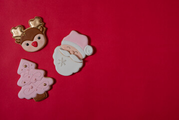 Flat lay composition with tasty homemade Christmas cookies on red background, space for text