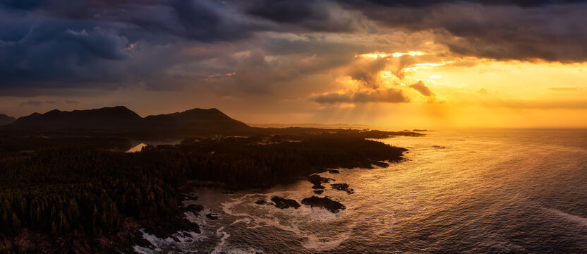 Ucluelet, Vancouver Island, British Columbia, Canada. Aerial Panoramic View of a Small Town near Tofino on a Rocky Pacific Ocean Coast. Dramatic Stormy Sunrise Sky.