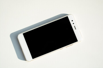 White smartphone on white background, isolated. Cell phone.