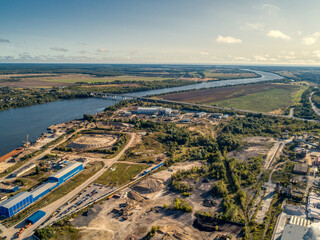 industrial plant on the bank of a large river, aerial view.