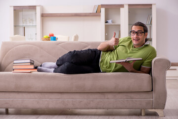 Fototapeta premium Young male student preparing for exams at home
