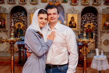 Fototapeta na wymiar beautiful married couple in the church. Christian family religious traditions. 