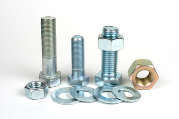 group of bolts and nuts made of metal on a white background