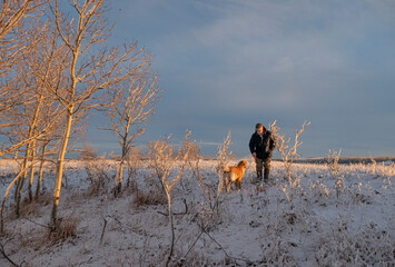 a man and his dog on a winter walk