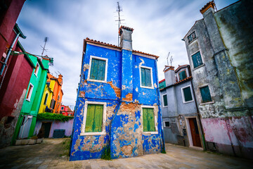Fototapeta na wymiar Colourful old abandoned building at Burano island near Venice, Italy