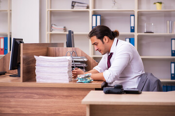 Young male employee extremely tired with excessive work