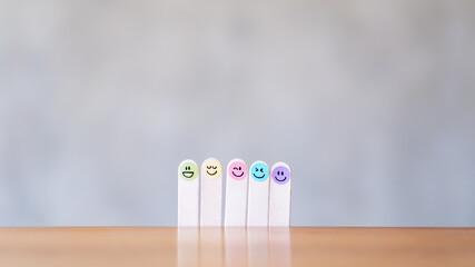 Colorful hand draw happy emotion faces on wooden stick with background