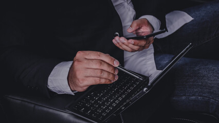 hands of businessmen are working with laptops on cars.while traveling to the office.