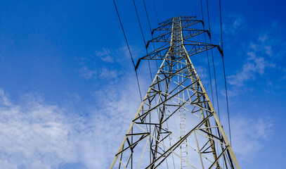 Electricity pole against blue sky clouds, Transmission line of electricity to rural, High voltage electricity pole on bright sky clouds background, electricity transmission pylon, Power distribution