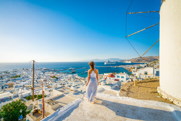 Female tourist looking at Mykonos island in Greece