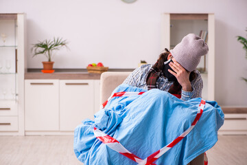 Young man suffering at home in pandemic concept