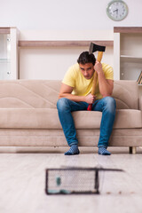 Young man and mousetrap at home