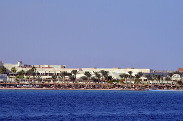 Fototapeta na wymiar Resorts and hotels at coast of Sharm El Sheikh from yacht. Sharm El Sheikh, Egypt