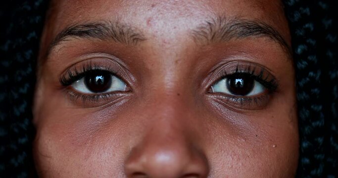 Close-up Teen African black girl eyes and face staring at camera