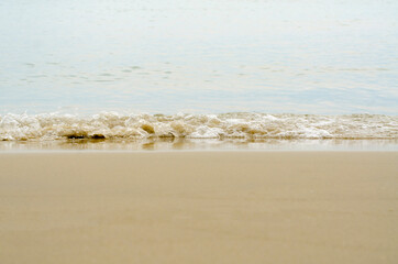 The sea waves hit the beach