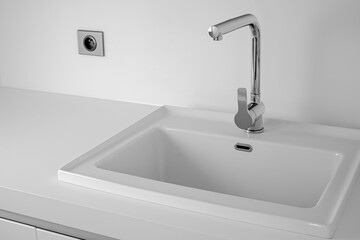 Modern bathroom interior with sink and chrome faucet.