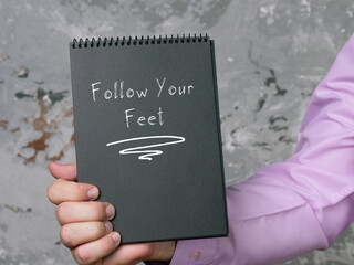 Lifestyle concept about Follow Your Feet with inscription on the sheet.