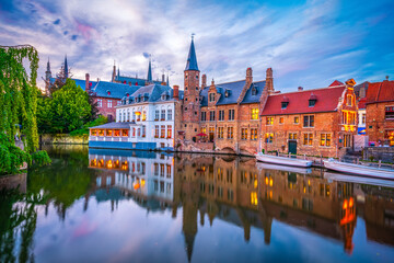 Fototapeta na wymiar Center of Brugge reflected in the water at sunset. Brugge is often referred to as The Venice of the North. Belgium